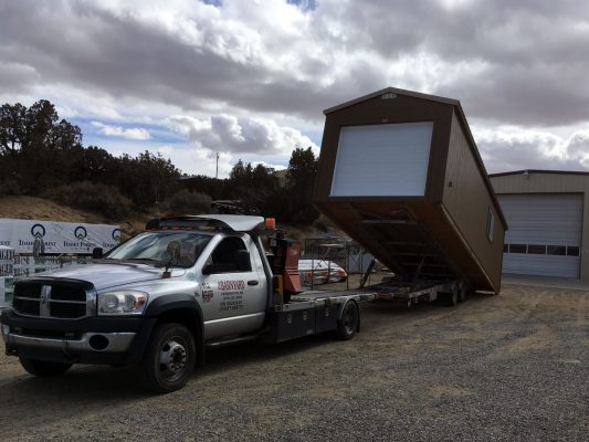 Loading a ranch-style garage onto a delivery trailer